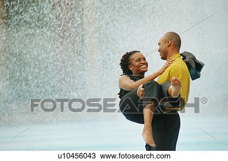 Couple enjoy water on a hot day View Large Photo Image Stock Image - Couple enjoy water on a hot day. Fotosearch