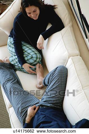 Couple hanging out on sofa View Large Photo Image Stock Image - Couple hanging out on sofa. Fotosearch