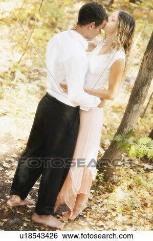 Stock Photograph - Couple kissing in nature. Fotosearch