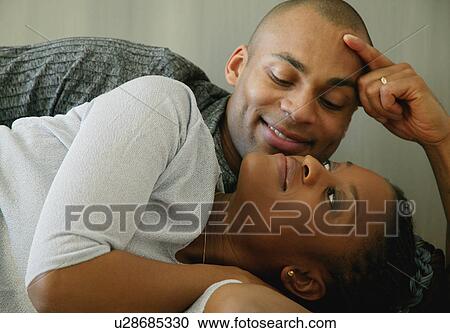 Stock Image - Couple lays together. Fotosearch