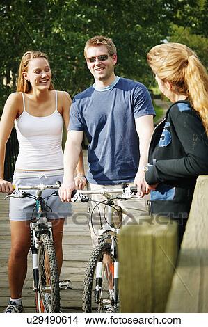 Couple on bikes View Large Photo Image Picture - Couple on bikes. Fotosearch