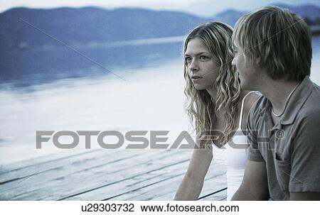 Stock Image - Couple sitting together. Fotosearch