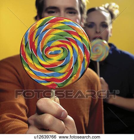 Stock Photograph - Couple with lollipops. Fotosearch