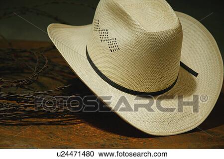 Stock Image - Cowboy hat and barbed wire still life. Fotosearch