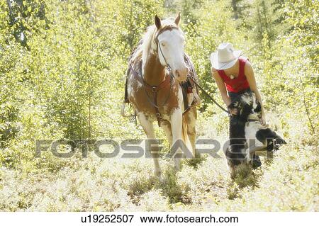 Cowgirl with horse and dog View Large Photo Image Stock Photo - Cowgirl with horse and dog. Fotosearch