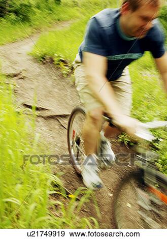 Stock Photo - Cycling down a path. Fotosearch