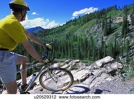 Cyclist enjoying Cliffside view View Large Photo Image Stock Image - Cyclist enjoying Cliffside view. Fotosearch