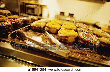 Picture - Donuts in a cafeteria. Fotosearch
