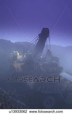 Drag line dumping bucket into ore truck View Large Photo Image Stock Image - Drag line dumping bucket into ore truck. Fotosearch
