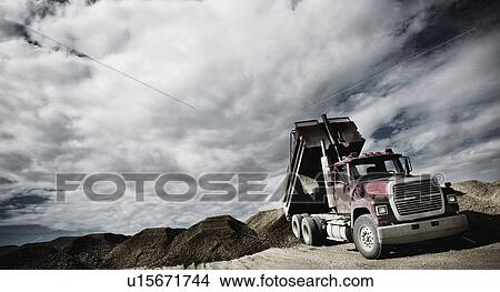 Dump truck unloading View Large Photo Image Picture - Dump truck unloading. Fotosearch