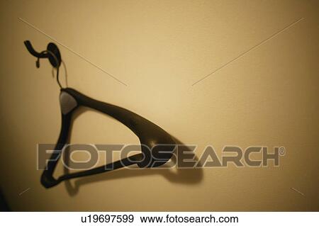 Stock Photo - Empty hanger on the wall. Fotosearch