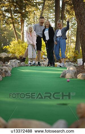 Stock Photo - Family goes mini golfing. Fotosearch