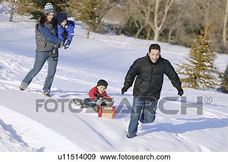 Family goes tobogganing View Large Photo Image Stock Photo - Family goes tobogganing. Fotosearch