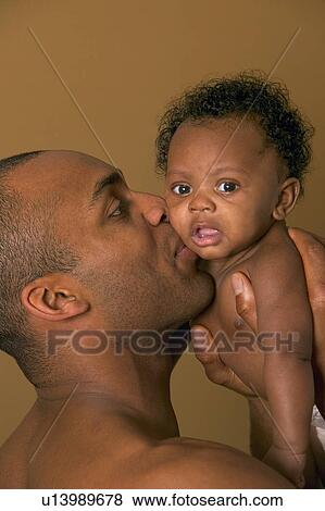 Stock Photo - Father holding baby. Fotosearch