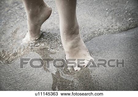 Stock Image - Feet in the water. Fotosearch
