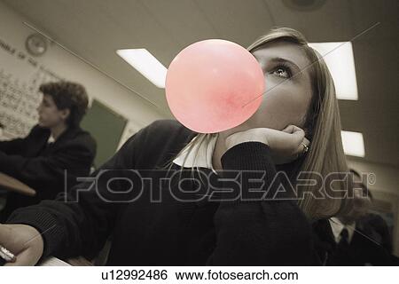 Female student blowing bubblegum View Large Photo Image Stock Photograph - Female student blowing bubblegum. Fotosearch