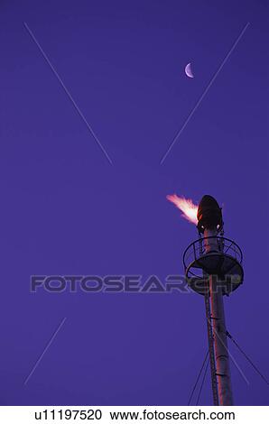 Stock Image - Flame on tower at gas plant. Fotosearch