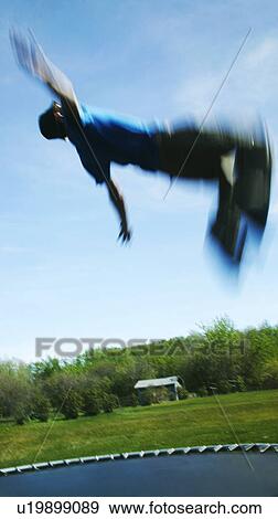 Flips on a trampoline View Large Photo Image Stock Photo - Flips on a trampoline. Fotosearch