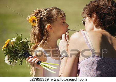 Stock Photo - Flower girl getting lipstick. Fotosearch