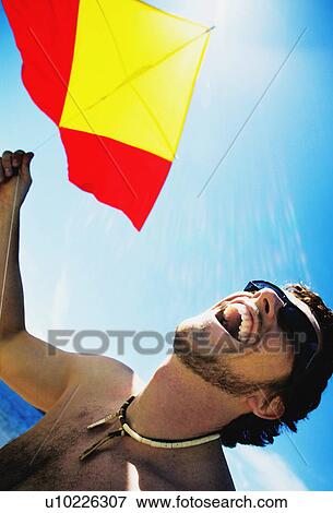 Flying a kite View Large Photo Image Stock Photo - Flying a kite. Fotosearch
