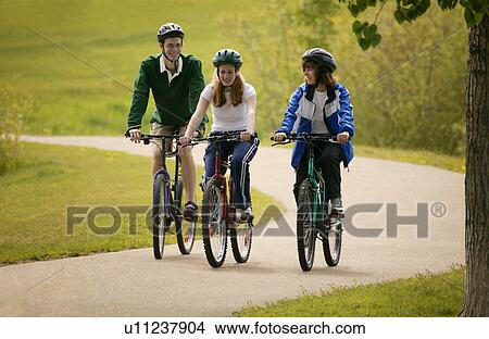 Friends cycling together View Large Photo Image Picture - Friends cycling together. Fotosearch