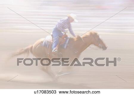 Stock Image - Galloping horse and rider. Fotosearch