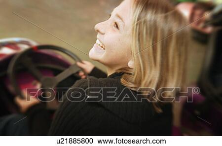 Stock Image - Girl at an amusement park. Fotosearch