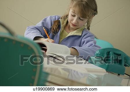 Stock Photo - Girl doing homework. Fotosearch