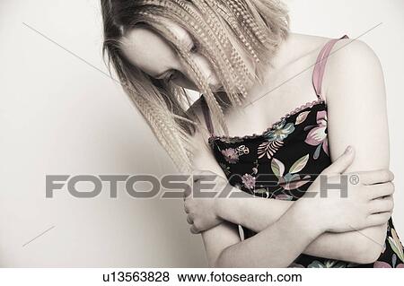 Stock Photo - Girl hangs her head. Fotosearch