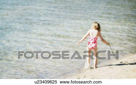 Girl playing in water View Large Photo Image Stock Photography - Girl playing in water. Fotosearch