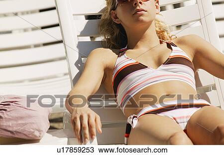 Girl sun tanning View Large Photo Image Stock Image - Girl sun tanning. Fotosearch