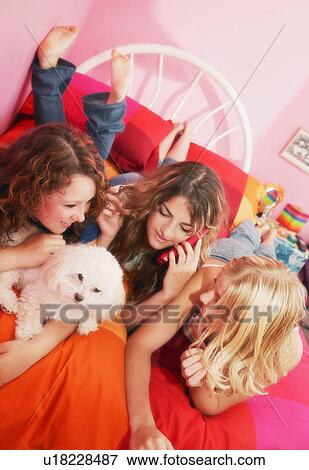 Stock Photo - Girlfriends talking on phone. Fotosearch