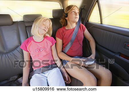 Stock Photograph - Girls in the back seat of a car. Fotosearch