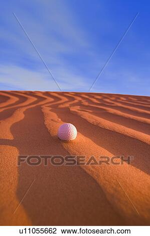 Stock Image - Golf Ball on Sand Dune Great Sand hills Sceptre Saskatchewan Canada. Fotosearch