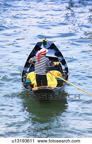 Gondolier navigating the canal of Venice Italy Europe View Large Photo Image Stock Image - Gondolier navigating the canal of Venice Italy Europe. Fotosearch