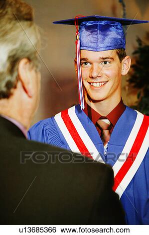 Stock Photograph - Graduate receiving diploma. Fotosearch