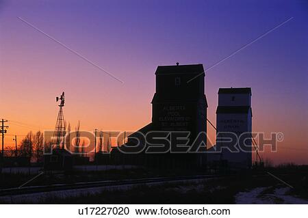 Stock Image - Grain elevators at sunrise/sunset. Fotosearch