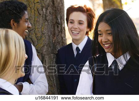 Stock Image - Group of diverse students at a break hanging out. Fotosearch