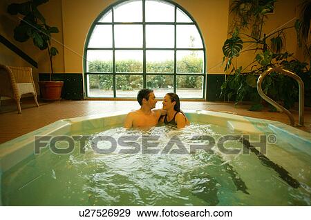 Stock Photo - Happy couple in hot tub. Fotosearch