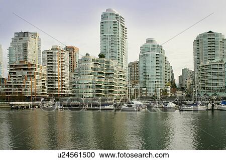 Stock Image - High rise buildings in a harbor. Fotosearch