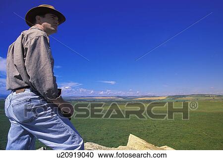 Hiker with binoculars on cliff edge View Large Photo Image Stock Image - Hiker with binoculars on cliff edge. Fotosearch