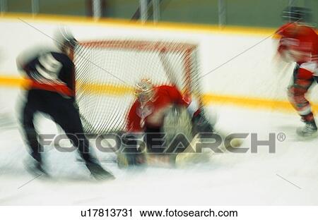 Ice hockey player shooting puck at goal View Large Photo Image Stock Image - Ice hockey player shooting puck at goal. Fotosearch