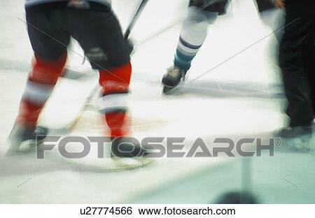Stock Photograph - Ice hockey players' legs. Fotosearch
