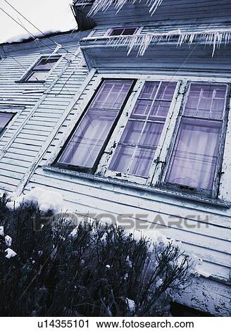 Stock Image - Icicles on house. Fotosearch