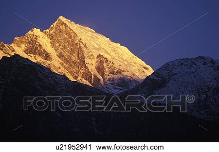 Illuminated mountain peak View Large Photo Image Stock Image - Illuminated mountain peak. Fotosearch