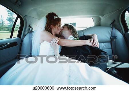 Stock Image - Kissing in the back seat. Fotosearch