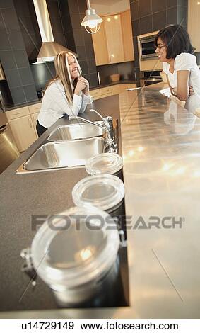 Stock Photo - Kitchen chat. Fotosearch