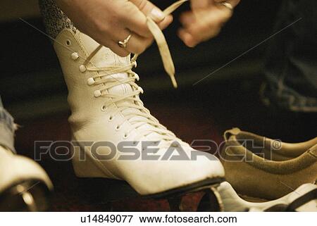 Lacing up skates View Large Photo Image Stock Photo - Lacing up skates. Fotosearch
