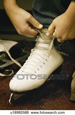 Lacing up skates View Large Photo Image Stock Photo - Lacing up skates. Fotosearch
