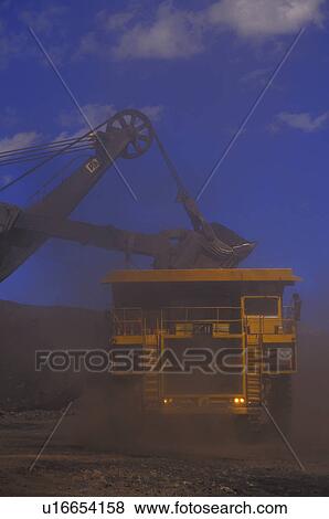 Large ore truck getting filled with drag line bucket View Large Photo Image Stock Photo - Large ore truck getting filled with drag line bucket. Fotosearch